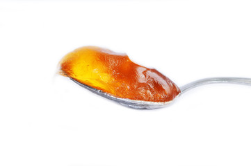 sweet yellow honey food in spoon isolated on white background