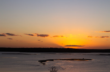 Fototapeta na wymiar Orange sun over the horizon in the sunset. Warm colors in the sunset.