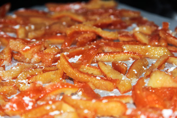 Homemade candied orange skins in powdered sugar