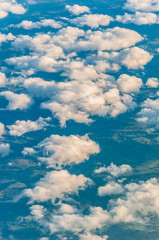 Fototapeta na wymiar sky seen from an airplane window with lots of clouds and contrasting colors