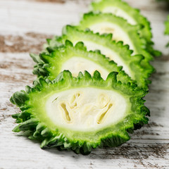 slices of raw karela on a table