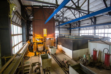 Mining headframe concrete collar surface mat with ore carts wagons