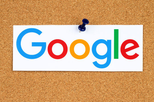 KIEV, UKRAINE - SEPTEMBER 02, 2015:New Google logotype printed on paper, cut and pinned on cork bulletin board.Google is USA multinational corporation specializing in Internet-related services.