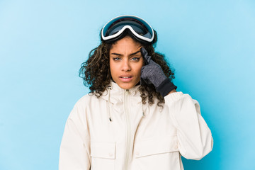 Young african american skier woman isolated showing a disappointment gesture with forefinger.