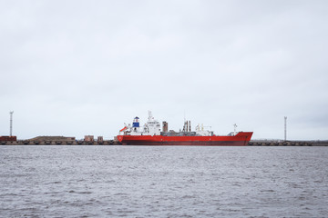 Big red ship in docks. Overcast day in winter.