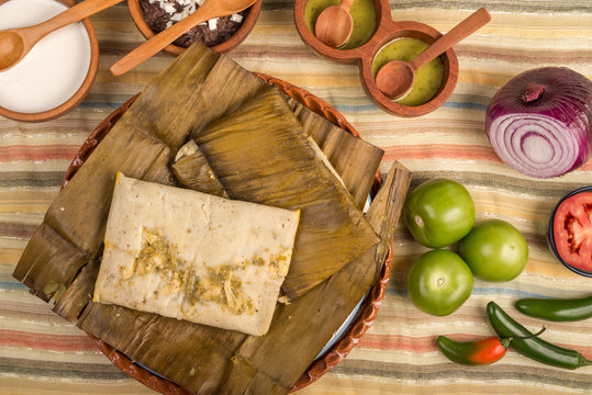 Tamal de Oaxaca, Mexican dish made with corn dough, chicken or pork and chili, wrapped in a banana leaves.