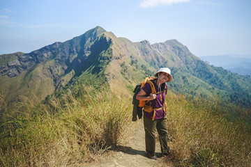 Fototapeta na wymiar Young woman hiking on the mountain landscape