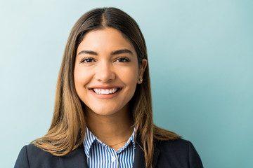 Pretty Hispanic Businesswoman Smiling In Studio - obrazy, fototapety, plakaty
