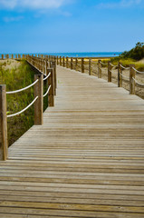 A wooden road leads to the sea