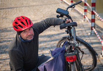Man at the bicycle outfit repairing his bike.
