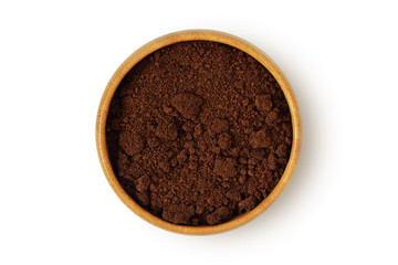 Coffee ground in wooden bowl on white background