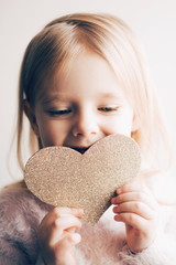 little girl with hand made paper heart. Vertical photo for instagram