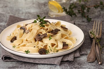 Pasta with mushrooms herbs and creamy sauce