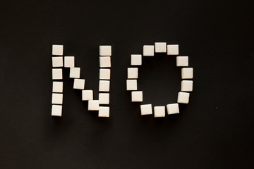 white sugar cubes NO sign on black background