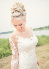 Fototapeta na wymiar wedding theme, bride outdoors moving around ,smiling and looking sideways