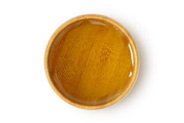 Oil in wooden bowl on white background - obrazy, fototapety, plakaty