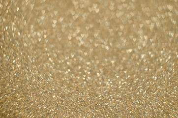 Abstract Christmast golden bokeh background with shining defocus sparkles. Blurred glitters shimmering dust macro close up, copy space for text logo