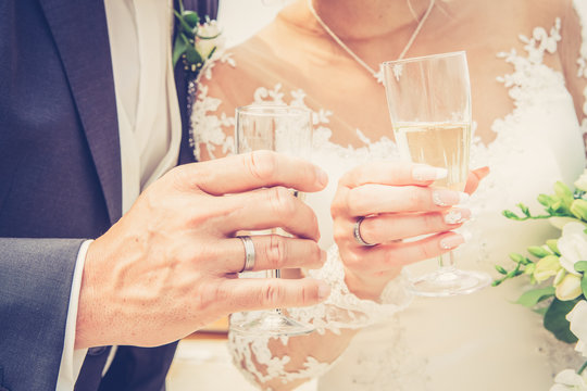 wedding theme picture with a close up bride and groom holding a glass of champagne