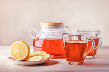 Hot tea with citrus on table, close-up.