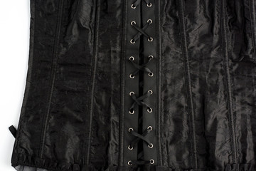 fragment of a black satin corset with lacing, back view, clothing item