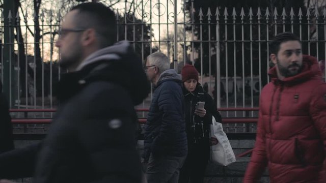 Adult woman outdoor at dusk smoking cigarette using smartphone &ndash; unhealthy, addiction, pensive concept