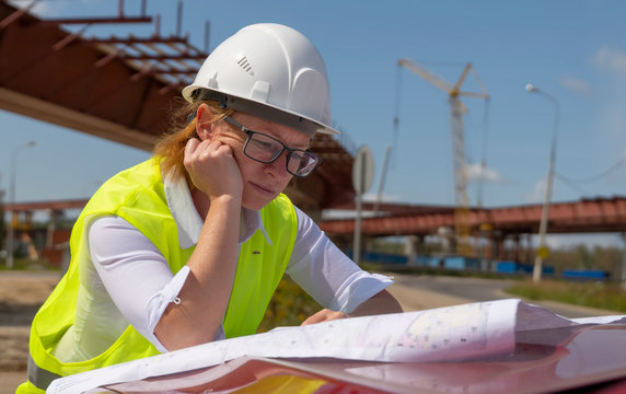 Female engineer working on project documentation at a construction site.