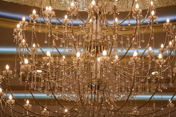 Large crystal chandeliers with lots of lights in a restaurant