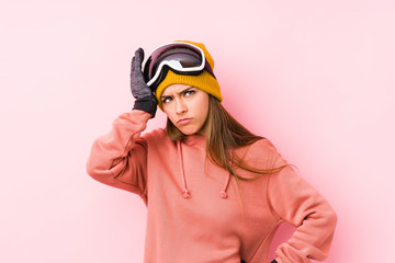 Young caucasian woman wearing a ski clothes isolated tired and very sleepy keeping hand on head.