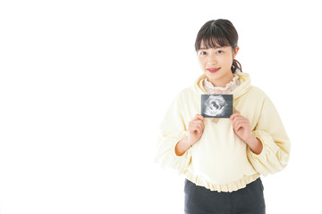 Fototapeta premium エコー画像を持つ若い妊婦の女性