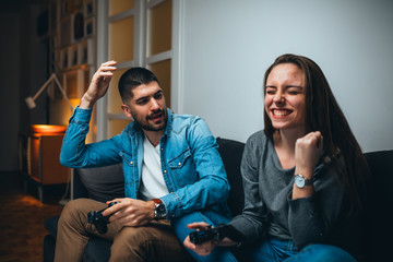 friends playing games on console at home