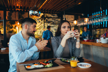 couple arguing in restaurant while having lunch