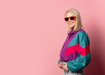 Beautiful blonde woman in sunglasses and 90s clothes