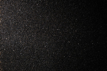  spot light background of black crushed anthracite grain with copy space for your text