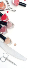 nail polishes and manicure devices on a white background