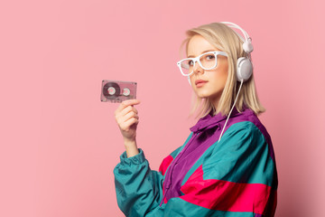 woman in 90s clothes with headphones and audio cassette