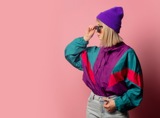 Beautiful blonde woman in sunglasses and 90s clothes