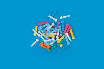 Needles for glucometer. A device for measuring blood sugar levels on a blue background.