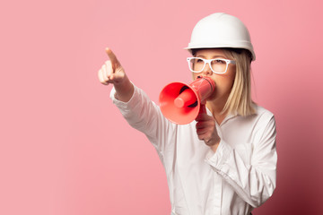 Woman in white shirt, glasses and helmet with loudspeaker