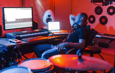 Guy have a job with project and mixing music indoors in the studio