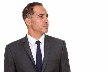 Face of mature handsome Persian businessman in suit thinking