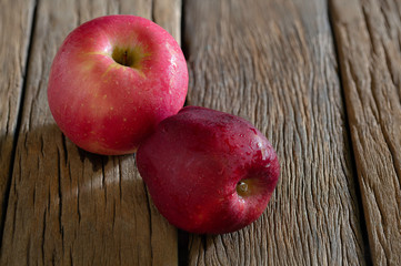Fresh red apples fruit put on the old wooden floor