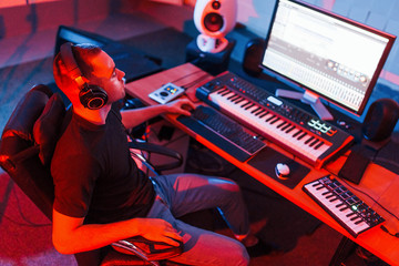 Professional sound engineer working and mixing music indoors in the studio