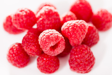 handful of raspberry berries on white background