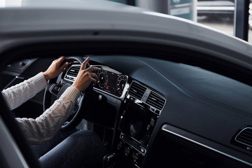 Particle view of man in formal wear that riding brand new car