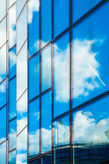 Reflections of the sky in the glass facade of the building