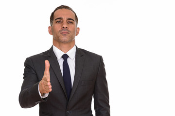 Portrait of mature Persian businessman giving handshake