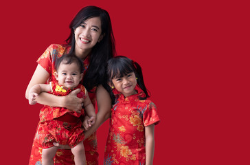 happy chinese new year. asian family with baby wearing red dress on white background