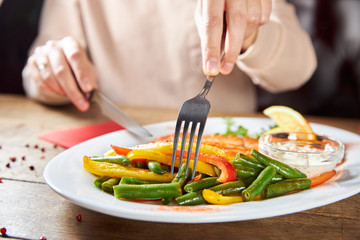 woman cutting vegetables in kitchen