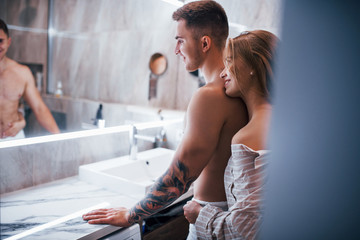 Young couple together in the bathroom at morning time