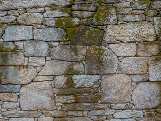 Part of a wall of old stones in different sizes -  background,  texture.
